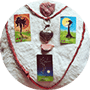 Oracle cards; with rhodonite and rhodochrosite, both pink crystals connected to the heart chakra with a heart shaped pyrite surrounded by a braided, red leather cord on a plush, white pillow.